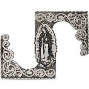 A custom belt buckle for women featuring an image of La Virgen de Guadalupe adorned with silver scrolls 